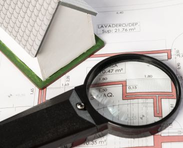 high-view-real-estate-plans-with-magnifying-glass (Demo) (Demo)